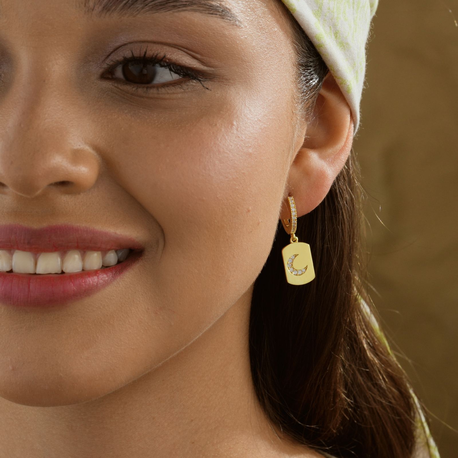 Elegant Moon Shaped Hoop Earring worn by a smiling woman, showcasing its detailed design and gold finish.