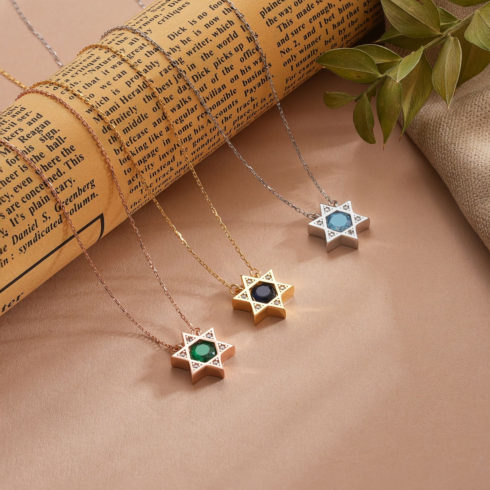 Star of David Necklace Elegant Silver displayed with gold and rose gold options on a vintage book background.