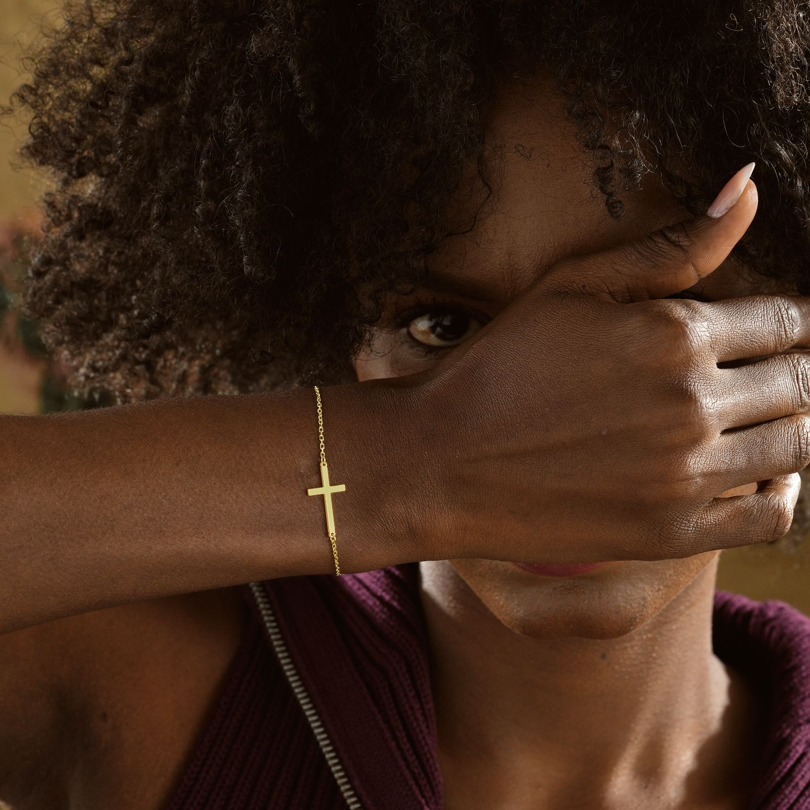 Elegant Sterling Silver Cross Bracelet worn on a woman's wrist, showcasing its gold filled finish and cross design.