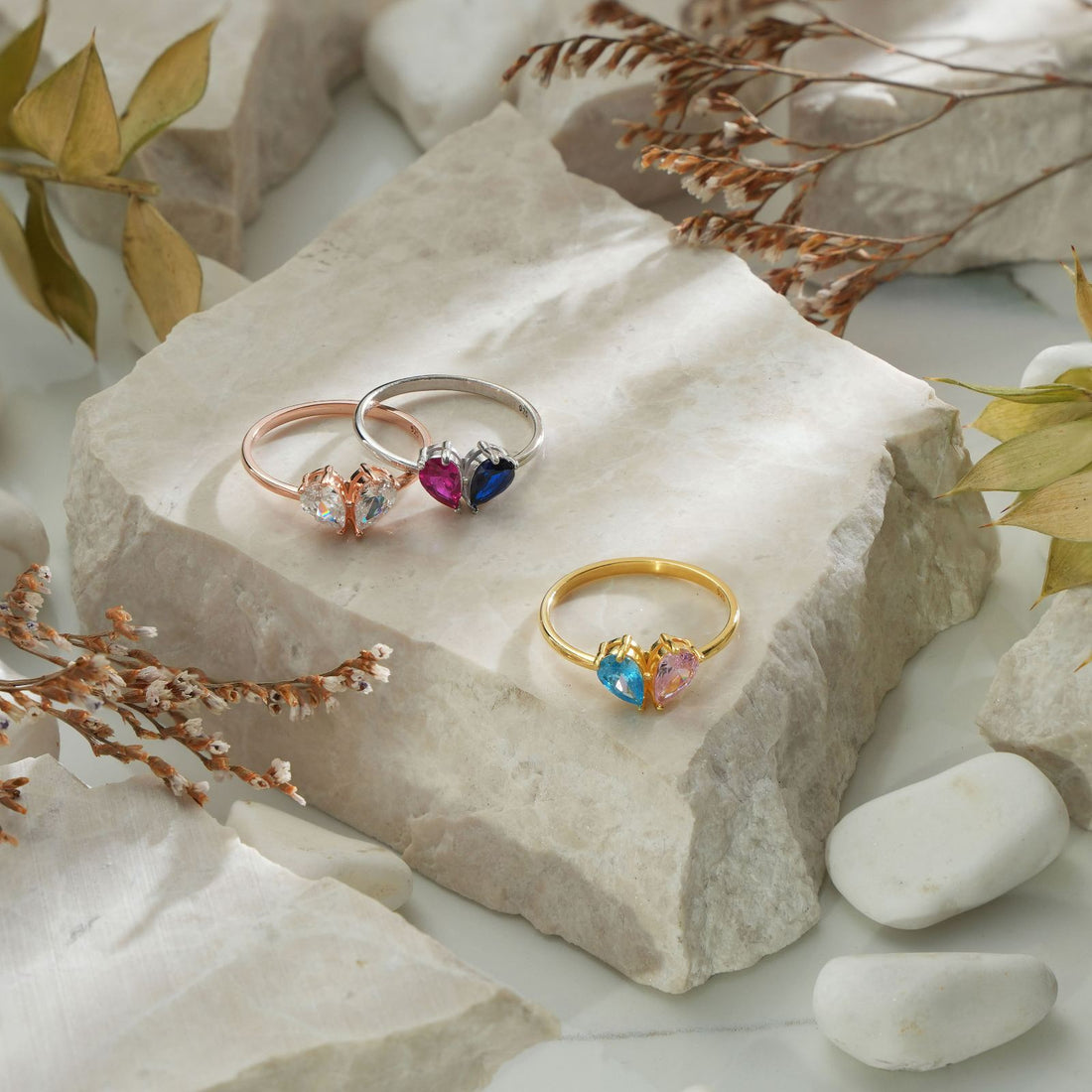 Model wearing a teardrop heart birthstone ring showcasing beautiful gemstones.