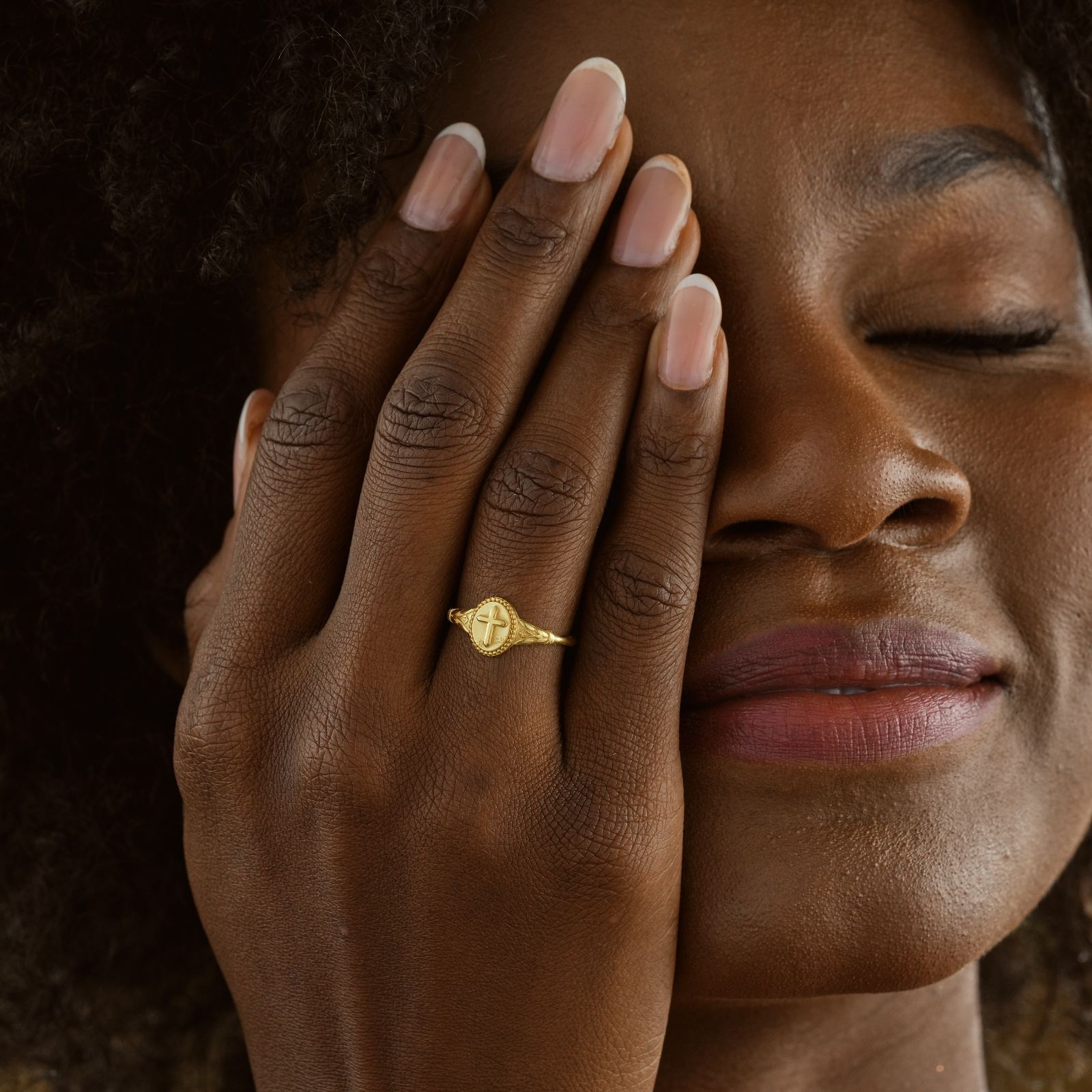 Woman wearing a Vintage Cross Signet Ring, showcasing intricate design and unique style.