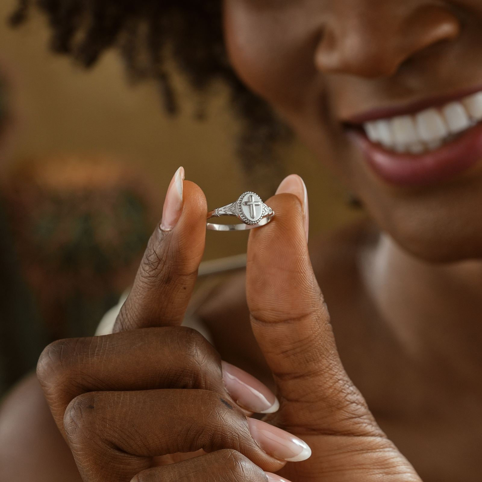 Vintage Cross Signet Ring displayed by a woman; showcasing intricate design and craftsmanship.