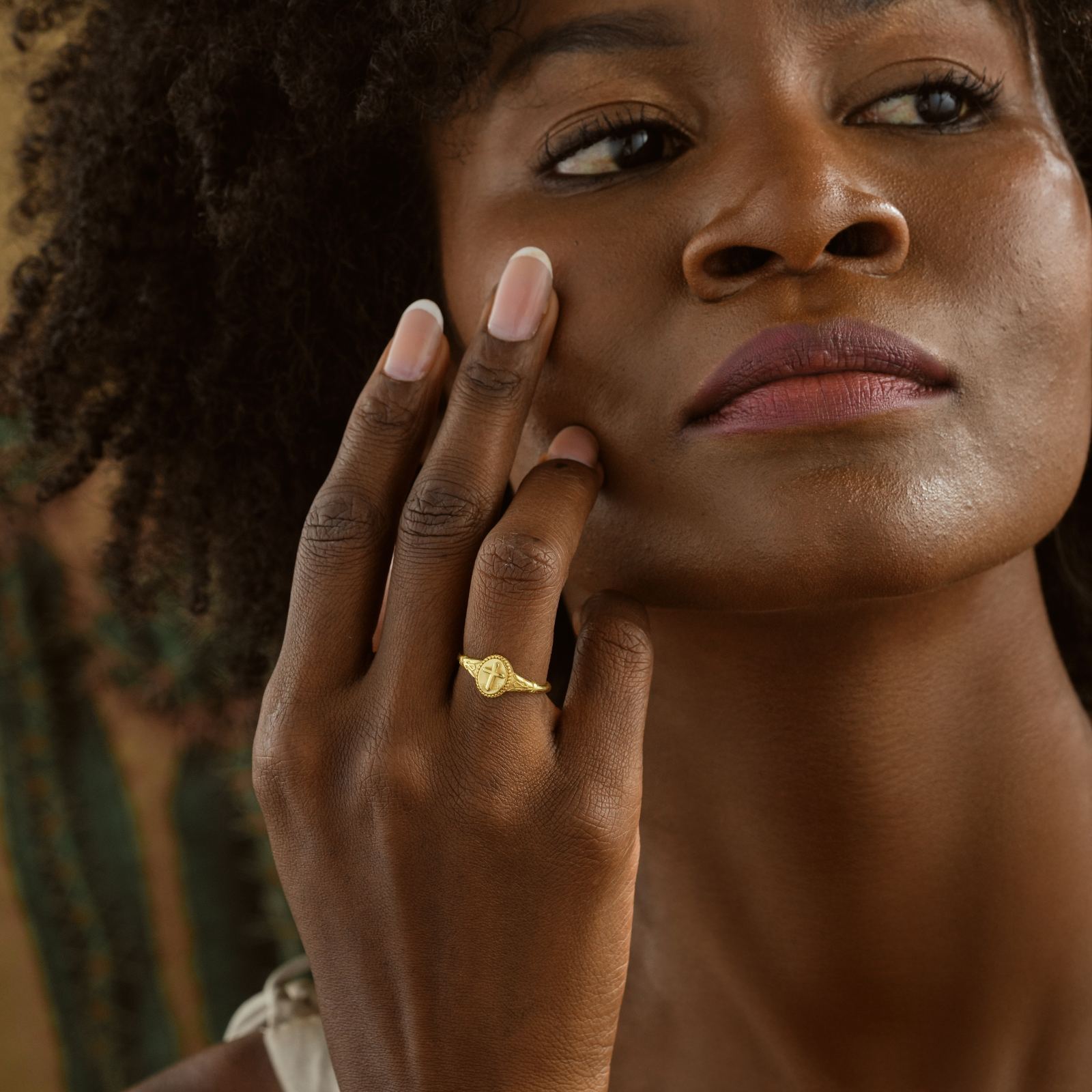 Woman showcasing a Vintage Cross Signet Ring in gold vermeil, highlighting unique style and faith symbol.