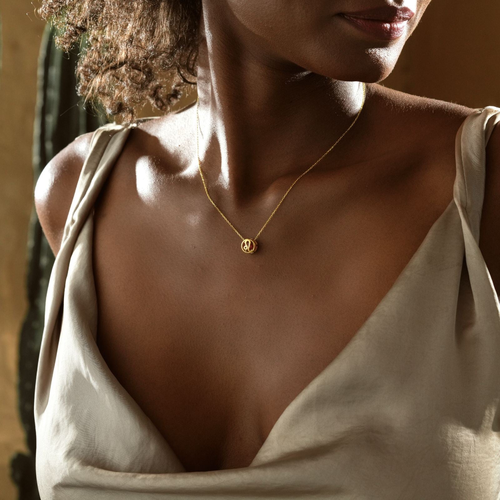 Zodiac Constellation Necklace worn by a woman, showcasing the astrology pendant with birthstone detail.