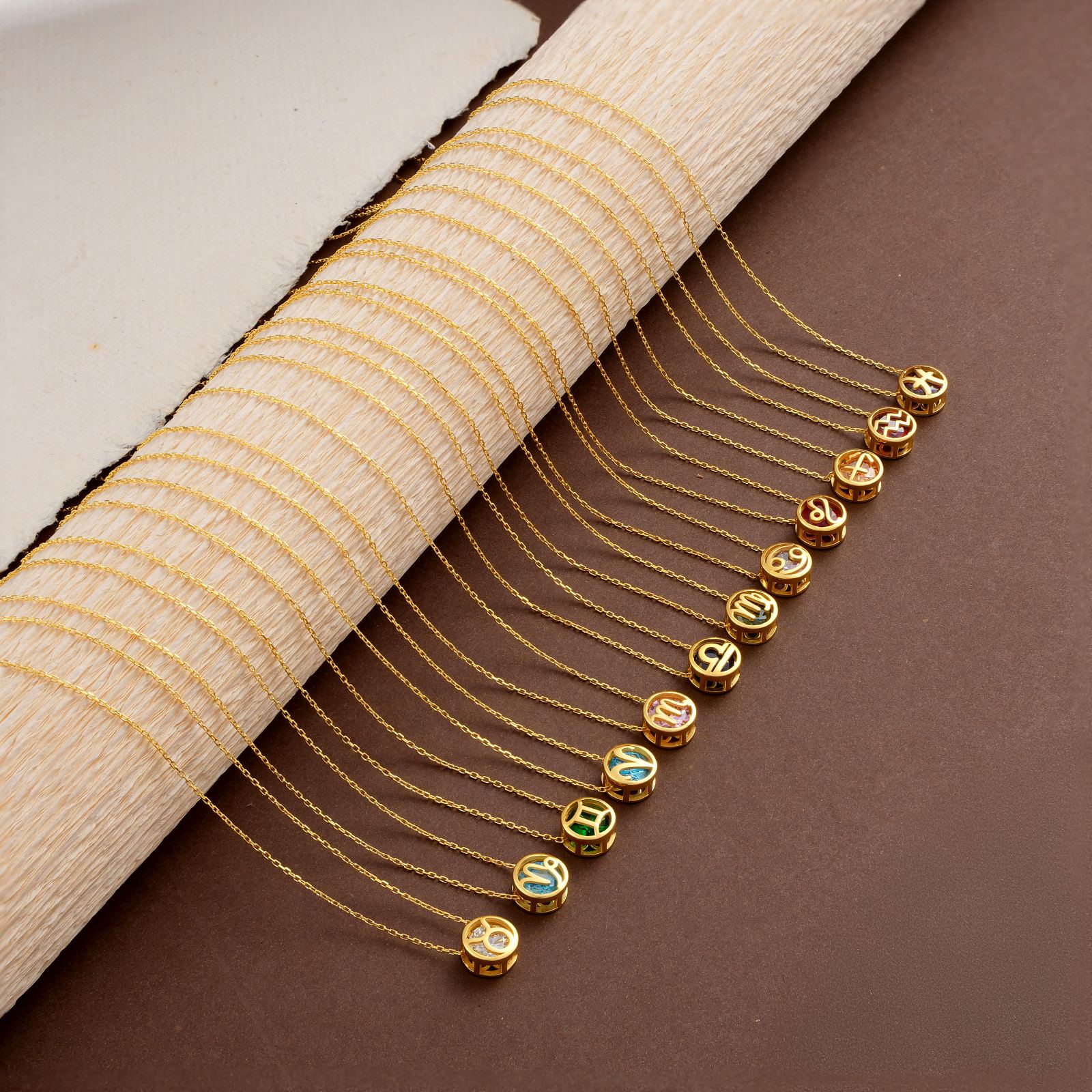 Zodiac Constellation Necklace displayed with colorful birthstone pendants on gold chains
