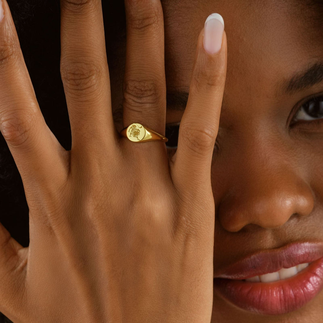 Personalized Zodiac Signet Ring worn on a hand, showcasing its gold vermeil finish and intricate design.