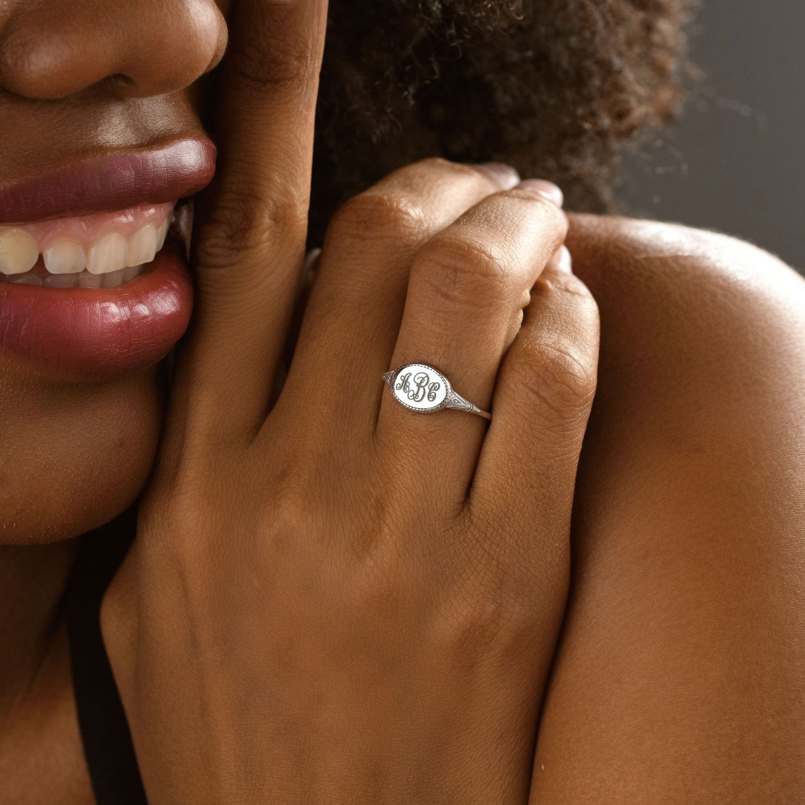 Close-up of a hand wearing a personalized Zodiac Signet Ring with intricate engraving, perfect for astrology lovers.